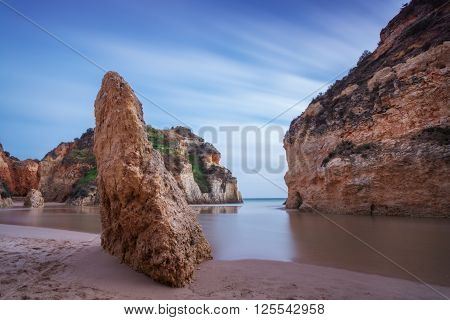 Bay Seascape with a rock in the foreground. In a long exposure.