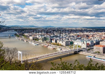 Peautiful panorama of Budapest city with Danube river, bridges and boats, Hungary. Cityscape with blue sky and gorgeous clouds.