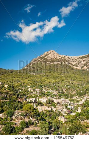 Beautiful view of a small mountain village Deia in Mallorca, Spain. Houses built on hills in Deia mountain village in Majorca island, Spain.