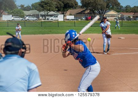 Softball pitcher throwing the curve ball to the batter.