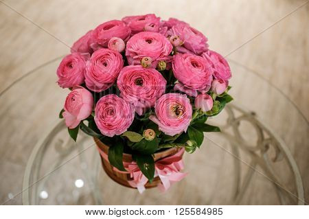 Pink persian buttercup flowers ranunculus bouquet on table
