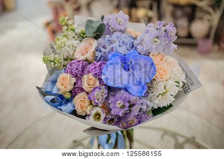 Bouquet of white and blue flower on table