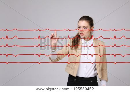 Doctor woman working with cardiogram lines