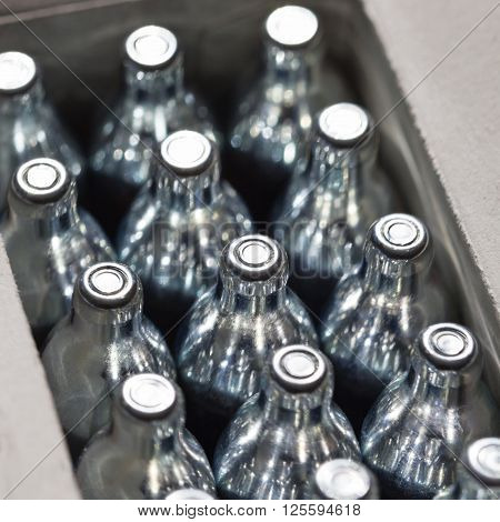 Soda chargers in carton box. Selective DOF, cole up shot.
