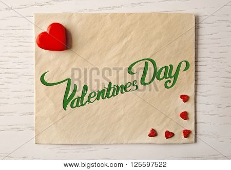 Blank present card with small hearts on wooden background