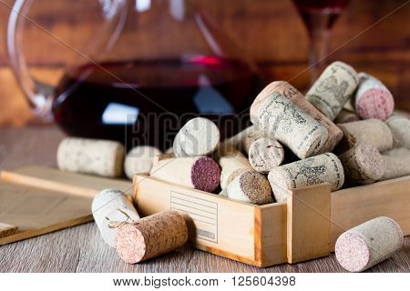 Background with glass of wine decanter and wine corcs. Wine concept