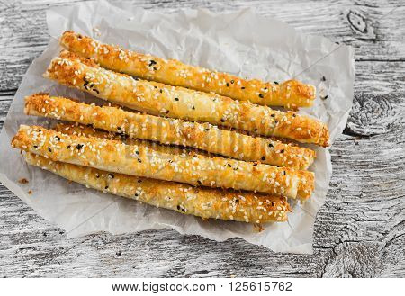 Homemade cheese bread sticks on a light wooden background