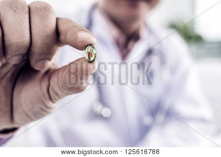 Hand of doctor holding anti-radiation pill, selective focus