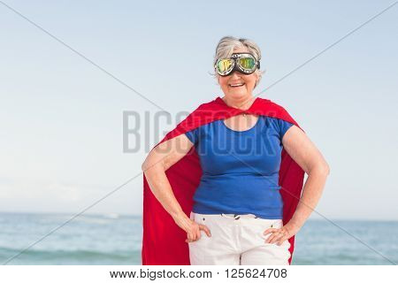 Senior woman wearing superwoman costume on a sunny day