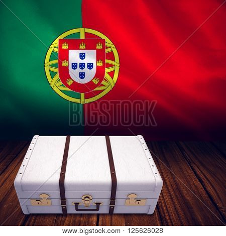 Suitcase against digitally generated portugese national flag