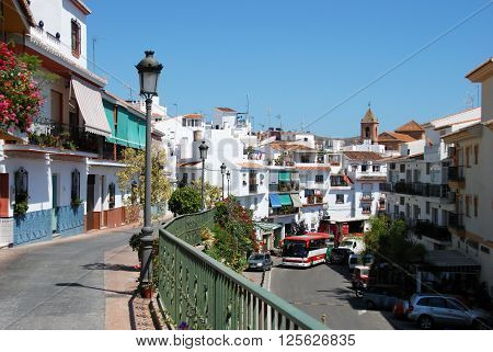 TORROX, SPAIN - JULY 1, 2008 - View along the main shopping street with the church to the rear Torrox Malaga Province Andalucia Spain Western Europe, July 1, 2008.