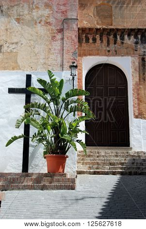 Church doorway and cross in the centre of the village Torrox Malaga Province Andalucia Spain Western Europe.