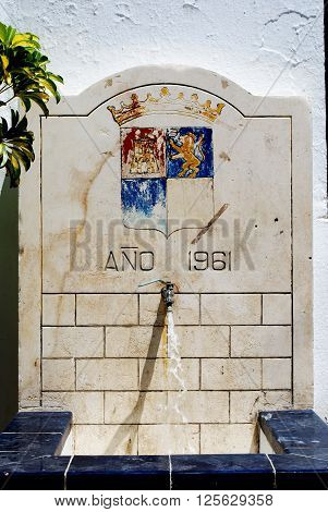 Drinking fountain with the town crest built in 1961 Torrox Malaga Province Andalucia Spain Western Europe.