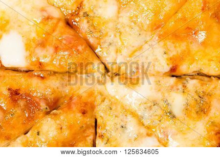 Closeup of melted cheese on sliced neapolitan pizza. Macro. Photo can be used as a whole background.