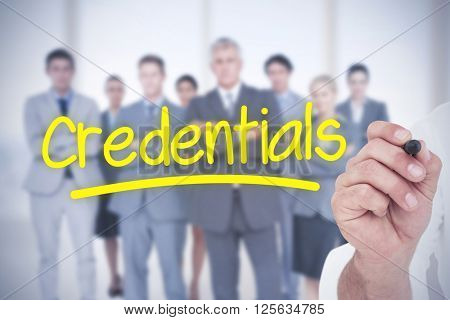 Male executive writing with marker against word credentials underlined