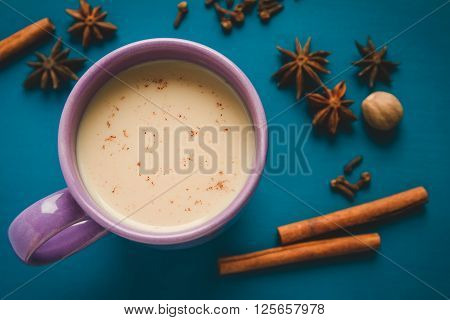 masala chai tea with spices and star Anise cinnamon stick nutmeg and cardamon on the blur background