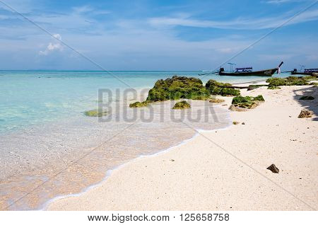 Water splashing. Crystal clear sea water beating against the rocks . Blue sky above the beach in the sun refreshing drops of ocean water. Sea waves break on the shore at Bamboo island Phi Phi Krabi PhuketThailand