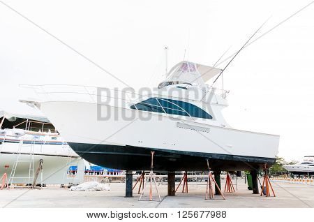 White small motor boat at dry shipyard for maintenance in Phuket Thailand