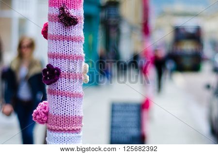 BATH SOMERSET UK - APRIL 14 2016 
Yarn bombing. An organised group cover poles and posts with knitting using wool to brighten up Milsom Street in the city centre