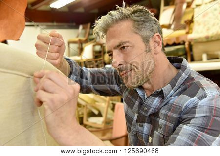 Man working in upholstery workshop