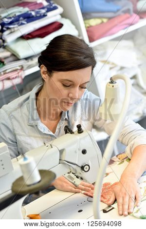 Portrait of seamstress working on sewing machine