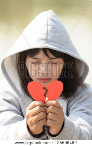 Sad Girl Praying to Reconcile from Red Broken Heart
** Note: Shallow depth of field