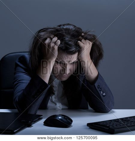 Stressed out businesswoman tearing her hair out