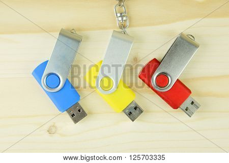 USB flash drive on the wooden background