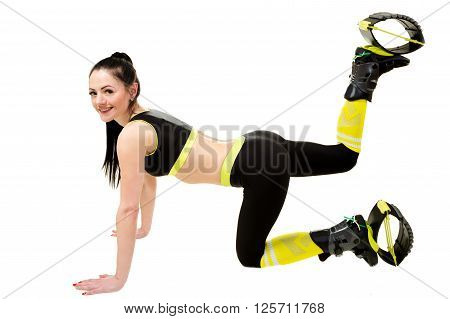 smiling young woman brunette with long hair in a kangoo jumps shoes doing exercises. Isolated on white background in studio