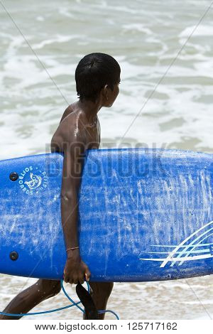 Causasian man and black child finishing surfing on the waves Sea beach