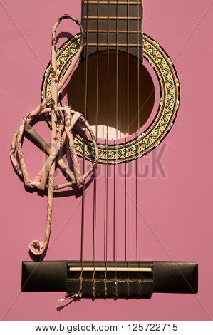 Violet guitar for children with treble clef closeup