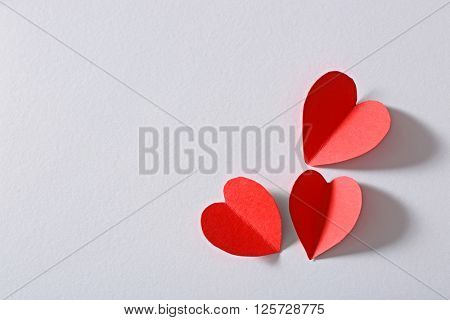 Red paper heart isolated on white background with copy space