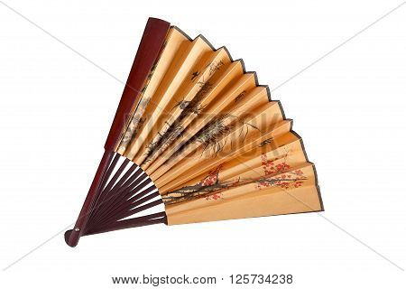 Fan with floral Japanese pattern. Half-opened, in the middle of composition.  Isolated on white. View from top.