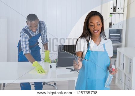 Young Janitors Cleaning Office