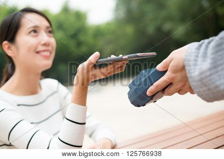 Woman pay with mobile phone by NFC technology