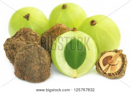 Dry and fresh amla over white background