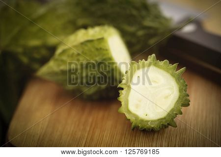 Sliced Green Momordica or karela on chopping board