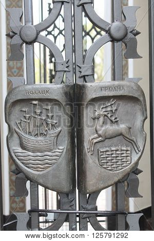 bronze emblems with symbols of the city on solid lattice decotared old chapel