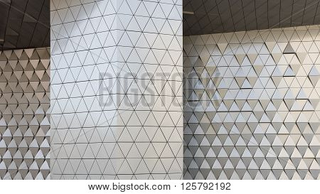 Abstract close-up view of modern aluminum ventilated facade of triangles