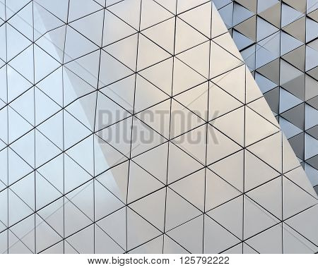 Abstract close-up view of modern aluminum ventilated facade of triangles