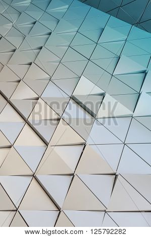 Abstract close-up view of modern aluminum ventilated facade of triangles