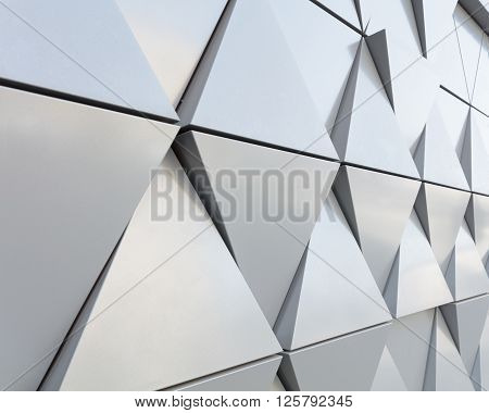Abstract close-up view of modern aluminum ventilated facade of triangles