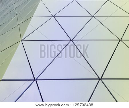 Abstract close-up view of modern aluminum ventilated facade of triangles