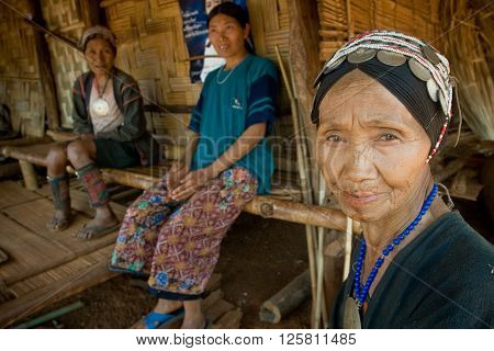 MAE SALONG,  CHIANG RAI province , THAILAND - JUN, 2004 : 
In the mountains of northern Thailand. An old woman from the Akha ethnic group. To save her money Akha women sew silver coins on headdress.