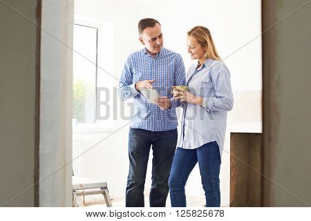 Woman Meeting With Architect Or Builder In Rennovated Property