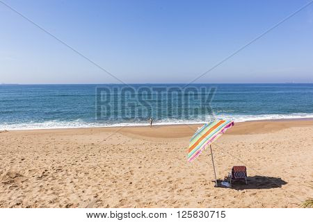Beach blue ocean horizon with holiday bather swimming coastline landscape.