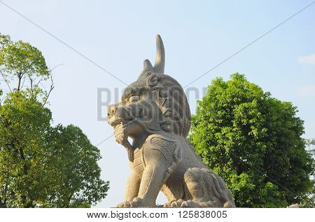 A carved chinese stone lion at the entrance of Luzhi water town in Jiangsu province China.