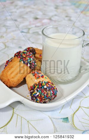 Cookies with sprinkles and a glass of milk