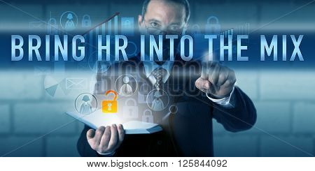 IT director is touching BRING HR INTO THE MIX on a translucent interactive display. Information technology concept and business function metaphor for involving HR departments in cybersecurity tasks.