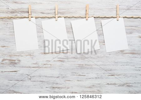 Blank paper sheet for text hanging on rope